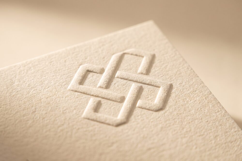 A shape raised in relief from heavy cream paper