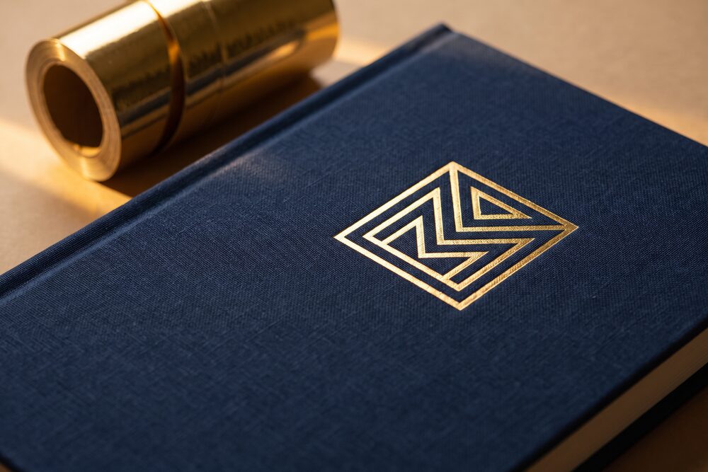 Bright gold foil stamped into a dark navy notebook cover